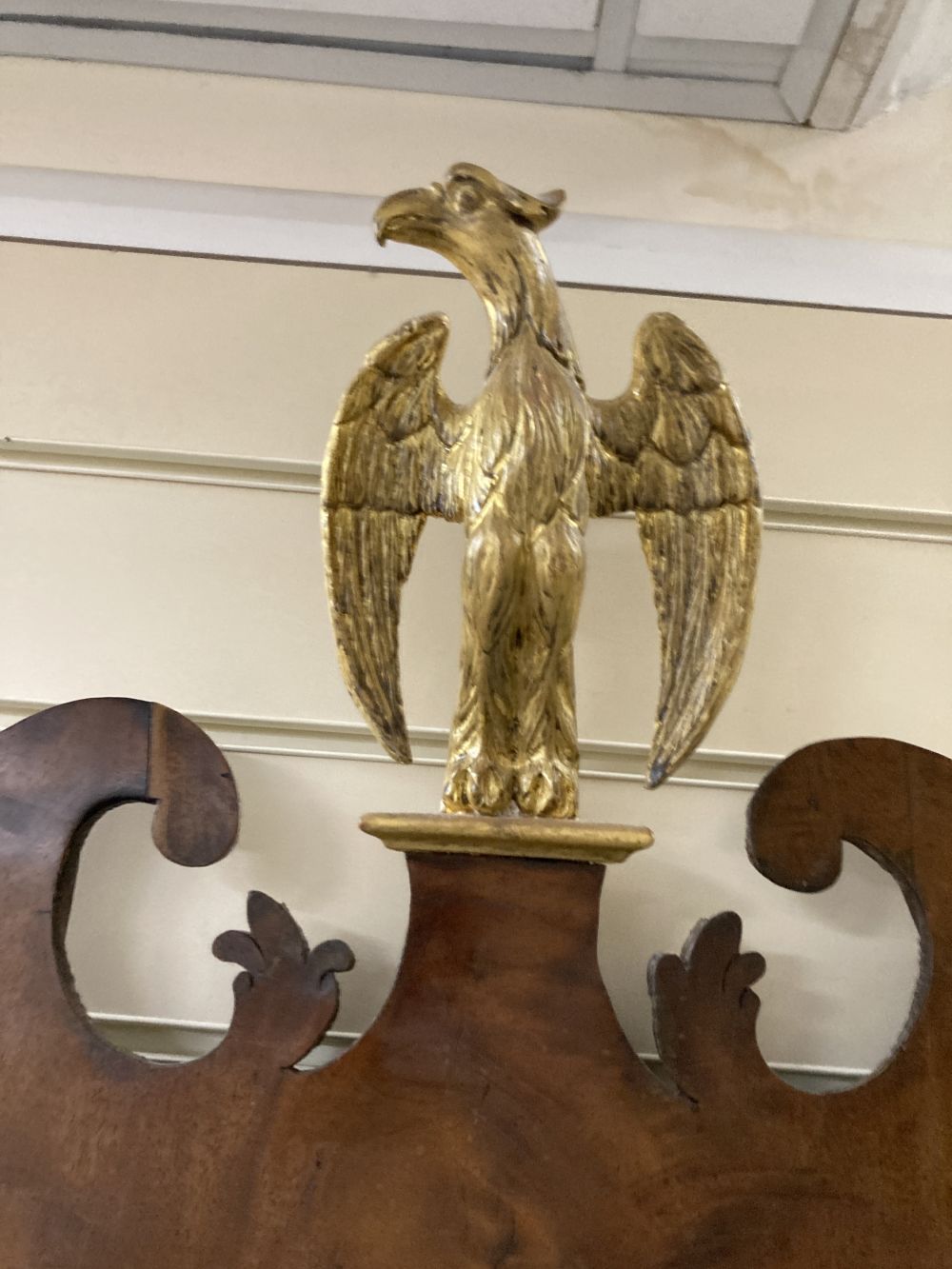 A George II parcel gilt walnut fret cut wall mirror, width 56cm height 120cm